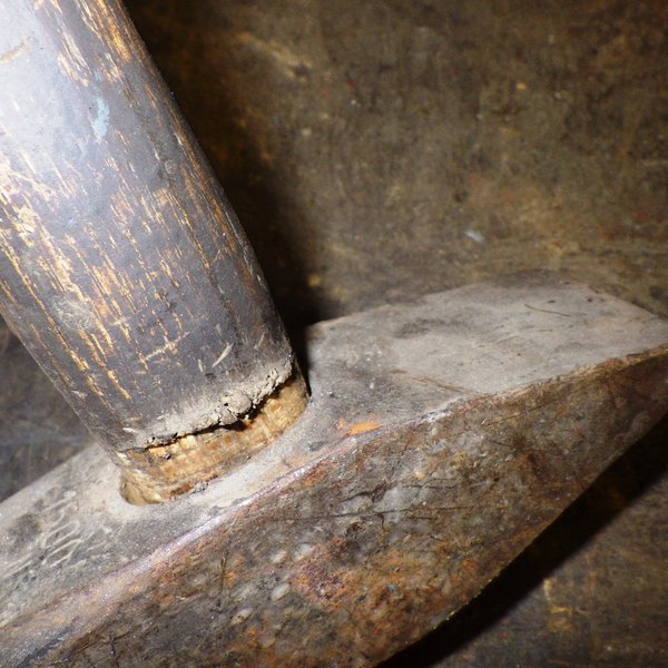 Das Bild zeigt den angebrochenen Holzstiel eines Hammers.